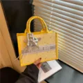 Yellow canvas tote bag with star pattern and silver pendant, stylish handbag for women daily use. - Yellow