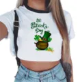 St. Patrick's Day clover print short sleeve crop top detail view showcasing holiday graphic. - S / White