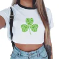 Close-up detail of the white crop top featuring green shamrock graphic print and contrast collar. - S / White