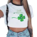 Close-up detail of white crop top with St. Patrick's Day clover graphic and black ringer collar. - S / White