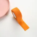 Orange self-adhesive finger bandage tape for writing protection and anti-callus use. - Orange