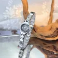 Elegant women's quartz watch with unique silver link band and small black dial. - Black Dial / Silver
