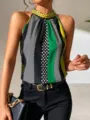 Detail view of the stylish color-block halter top with chic polka dots and green stripes. - Blue