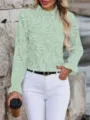 Detail view of a chic light green abstract print long sleeve blouse with ruffled mock neck. - Light Green