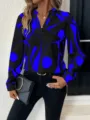 Detail shot of abstract print V-neck long sleeve blouse, featuring stylish black and blue pattern. - S / Blue