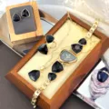 Elegant irregular watch four-piece set with striking black geometric stones and gold-tone finish for women. - Black
