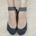 Detailed close-up view of dark grey cotton lace-trimmed Lolita boat socks worn on feet. - One Size / White