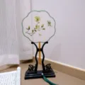 Traditional Chinese embroidered round fan detail with floral and butterfly pattern on wood stand. - Style 3