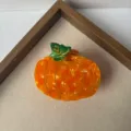 Orange pumpkin hair claw clip, cute autumn fruit hair accessory detail close-up view. - Small Pumpkin