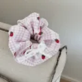 Close-up of sweet pink strawberry plaid scrunchie with cute white lace bow detail. - Scrunchie / Pink Strawberry