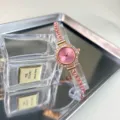 Detailed shot of pink crystal quartz women watch with rhinestone bracelet strap and tray. - Pink