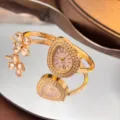 Luxury gold bangle quartz watch with teardrop dial and crystal clover motif for women. - Gold