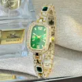 Close-up detail of the luxury green dial quartz watch with sparkling rhinestones and gold strap. - Green