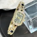 Elegant women quartz watch with rhinestones gold tone bracelet and black stone accents. - Black