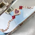 Heart dial rhinestone clover bracelet quartz watch for women, elegant rose gold fashion timepiece. - Red