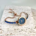 Women's rose gold quartz watch with blue crystal rhinestone adjustable bracelet strap. - Blue
