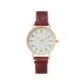 Nahaufnahme des roségoldenen Zifferblatts, strukturierte weiße Fläche und rotes Armband. - Rot