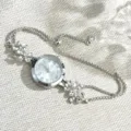 Silver rhinestone flower bracelet quartz watch for women, stylish pull-type adjustable chain. - Silver