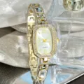 Elegant women quartz watch with rhinestone oval dial and fashionable gold chain strap. - White
