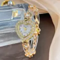 Luxus goldene Herz Strass Quarzuhr für Damen, elegantes funkelndes Zifferblatt Design. - Gold