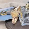 Close-up of women quartz watch, sparkling gold dial, ceramic link strap, elegant wristwear. - Gold