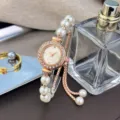 Elegant women's quartz watch featuring a crystal bezel, pearl bracelet, and adjustable design. - White