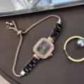 Detail view of women quartz watch, square rhinestone bezel, black crystal link bracelet. - Black