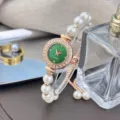 Elegant women's pearl bracelet watch featuring a green dial and sparkling rhinestone bezel. - Green