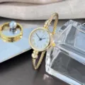 Elegante goldene Spangen-Quarzuhr mit römischen Ziffern und Draht-Manschettenarmband für Frauen. - Gold Römische Ziffern