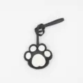 Black and white leather cat paw bag charm and cute keychain detail accessory for daily use. - Black and White