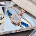 Elegant rose gold square quartz watch for women with blue crystal rhinestones and drawstring. - Blue