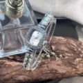 Detail shot of elegant women's square rhinestone quartz watch with sliding chain bracelet. - Silver