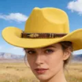 Yellow wool felt western cowboy hat with ethnic band and metal feather for outdoor travel style. - Yellow