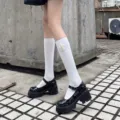 Detail view of white mid-calf socks with delicate pearl flower decor paired with black shoes. - One Size / Sunflower Pearl Plain Calf Socks / White
