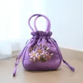 Purple silk handbag featuring exquisite floral ribbon embroidery, elegant drawstring pouch for wear. - Purple