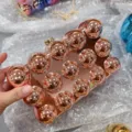 Close-up detail of the rose gold acrylic spherical clutch bag, showing the 3d ball studs design. - Champagne