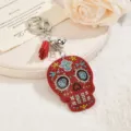 Detailed view of a sparkling rhinestone skull keychain and bag charm in red velvet style. - Red
