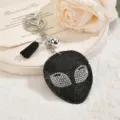 Schwarzer Strass Alien Schlüsselanhänger mit Quaste, stilvoller Taschenanhänger Geschenk. - Schwarz