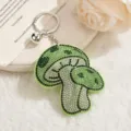 Green rhinestone mushroom keychain close-up, sparkling crystal bag charm and pendant. - Fruit Green
