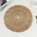 Detailed close-up of round paper woven placemat featuring textured fringe and center hole. - 38 cm / Brown