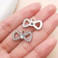 Silver tone rhinestone bow pendant charm for DIY jewelry making, necklace bracelet accessories. - Electroplated Point Drill Bowknot (27096) / 1 Piece (23x14mm) / Silver