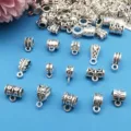 Close-up details of antique silver metal large hole pendant bail charms for DIY jewelry making. - Mixed Large Hole Bails (M79)
