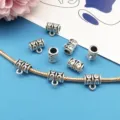 Close-up detail of silver DIY large hole bail beads, perfect for charm bracelet making. - Style 8911 (9*10mm)