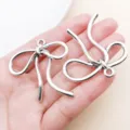 Antique silver bowknot metal charms for DIY bracelets, necklaces and keychains jewelry making. - Hollow Bowknot Style (26997) / 1 Piece (42x42mm) / Antique Silver