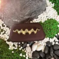 Textured frosted box clutch detail with elegant gold wave metal decoration for evening dress events. - Brown