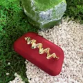 Red frosted box clutch with metallic gold wave decor, exquisite evening party handbag detail view. - Red