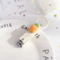 Cute pineapple design portable folding nail clipper in creamy white, compact manicure tool. - Pineapple