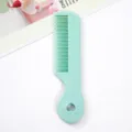 Mini candy-colored hair comb for kids, portable plastic hair styling tool with heart hole. - Individual Packaging / Green