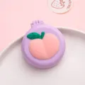 Mini portable folding hair comb with cute peach design, compact travel air cushion brush for daily use. - Purple Base Peach