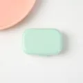 Mintgroene draagbare contactlensdoosje, een compacte reizen contactlens opbergdoos. - Lichtgroen